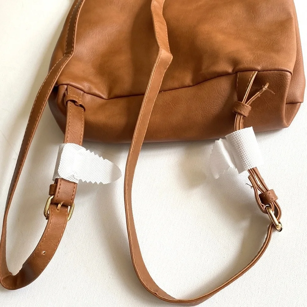 Brown backpack with zipper‎ accented detailing on front, NWOT